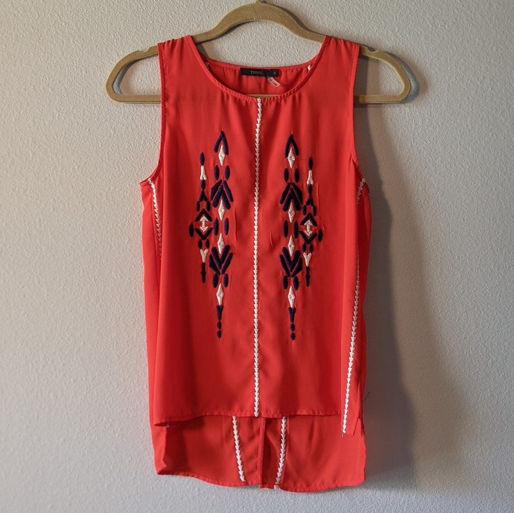Red blouse with white and blue embroidery